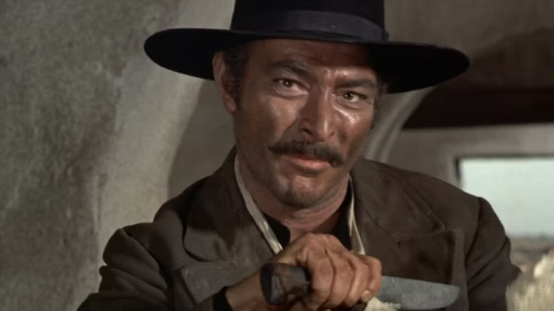 Angel Eyes holding a knife in "The Good, the Bad and the Ugly"
