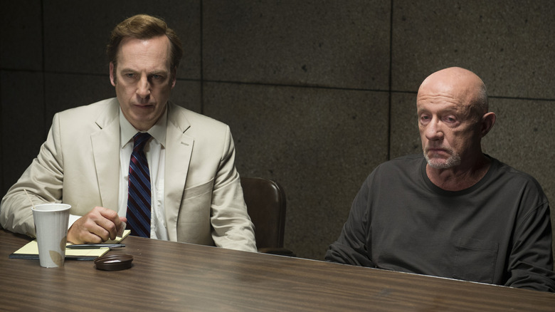 Jimmy McGill sitting at an interrogation table with Mike Ehrmantraut in "Better Call Saul."