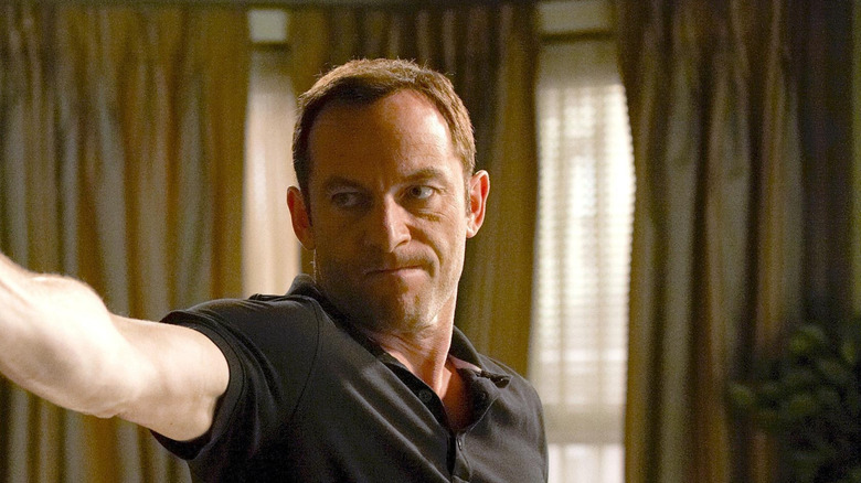 Michael Caffee holding and pointing a gun