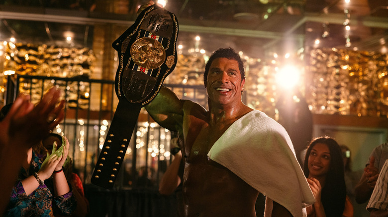 Mark Kerr holds a belt aloft in "The Smashing Machine"