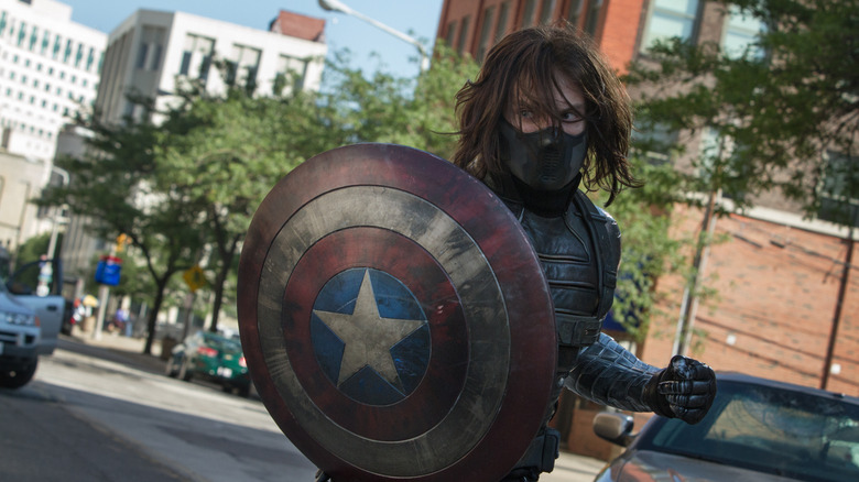 Bucky as the Winter Soldier holding Cap's shield in Captain America: The Winter Soldier