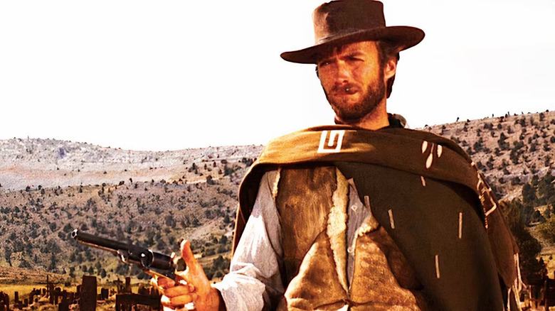 The Man With No Name holds up a revolver while smoking a cigar in "The Good, the Bad, and the Ugly"