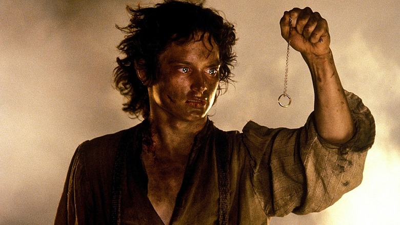 Frodo Baggins holds the one ring as he stands at the top of Mount Doom in "The Return of the King"
