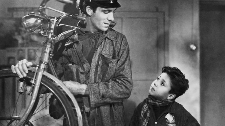 Antonio clutching a bike next to his son in Bicycle Thieves (1948)