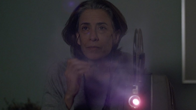 Eunice Paiva wistfully watching old home movies in I'm Still Here (2024)