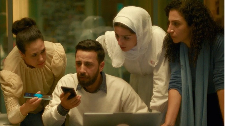 Red Crescent volunteers listening intently to Hind Rajab's call in The Voice of Hind Rajab (2025)