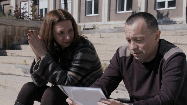 A pair of journalists going over notes in Collective (2020)