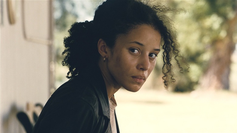 Willa Ferguson sitting leaning forward in One Battle After Another (2025)