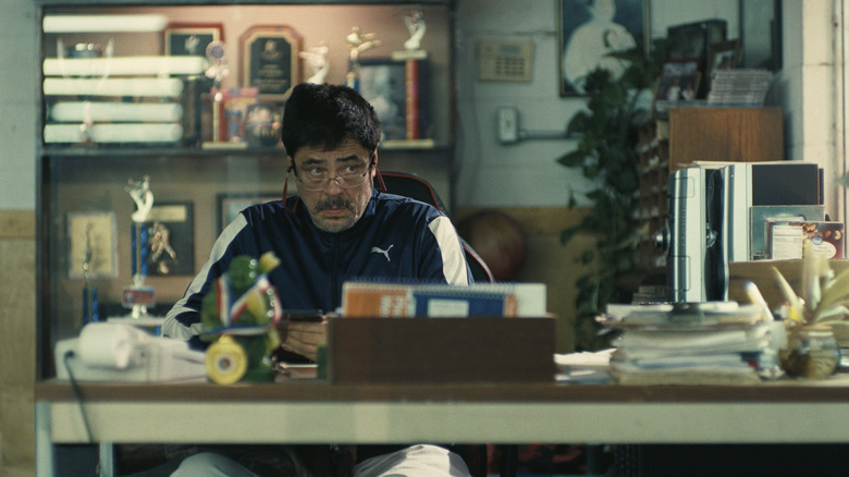 Sensei Sergio St. Carlos at his desk in One Battle After Another (2025)