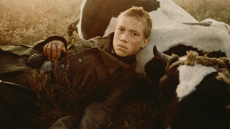 Floyra lying next to a cow in Come and See (1985)