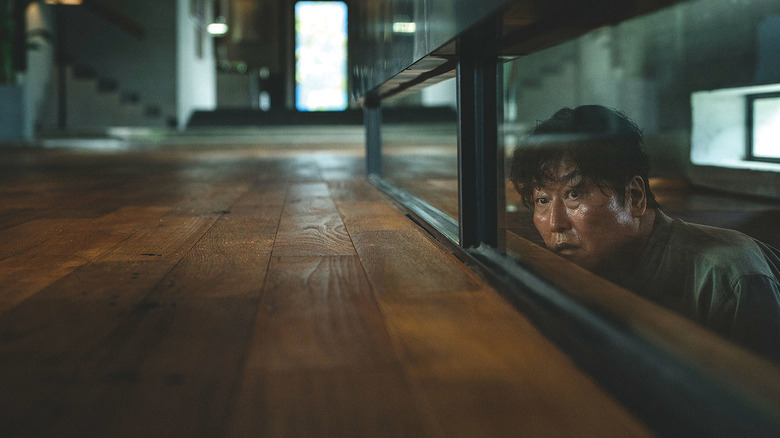 Kim Ki-taek hiding in Parasite (2019)