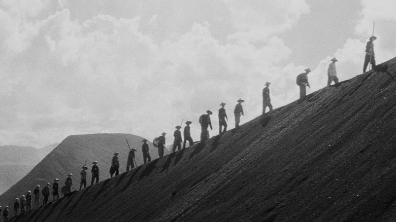 Human beings walking single-file in The Human Condition I: No Greater Love (1959)
