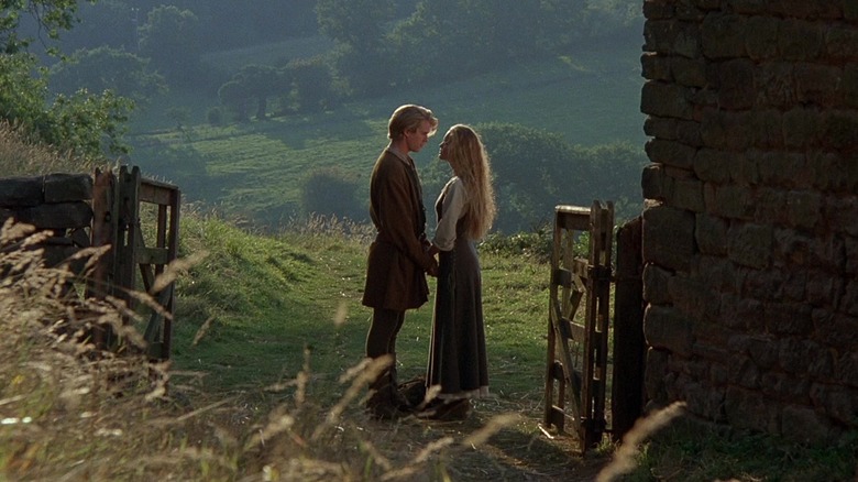 Buttercup and Westley hold hands