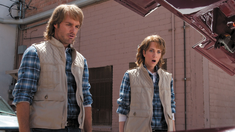 MacGruber and Vicki looking under a car hood in "MacGruber"