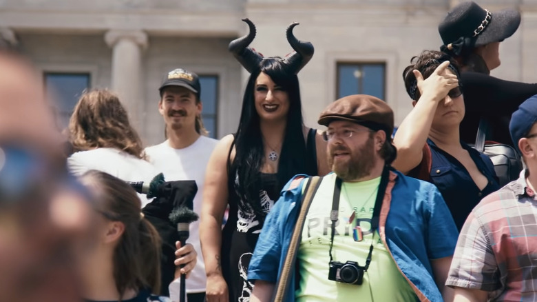 Woman wears devil horns
