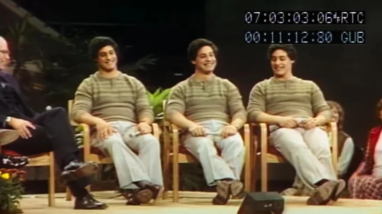 Three Identical Strangers smiling