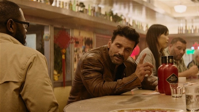 Roy gestures as he talks to Dave in "Boss Level" (2020)