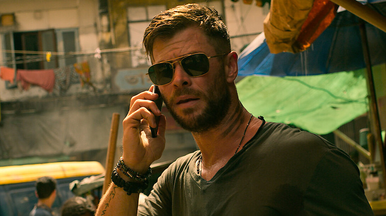 Tyler in sunglasses on the phone in "Extraction" (2020)