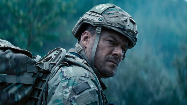 81 in fatigues turning to his right in 