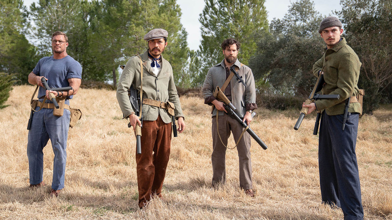 Anders, Gus, Freddy, and Henry holding weapons in "The Ministry of Ungentlemanly Warfare" (2024)