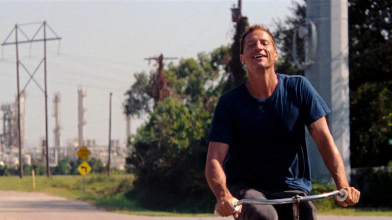 Mikey riding his bike and smiling in Red Rocket