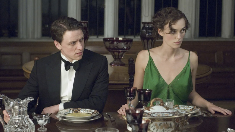 Robbie and Cecilia sit next to each other at a formal dinner in "Atonement" (2007)