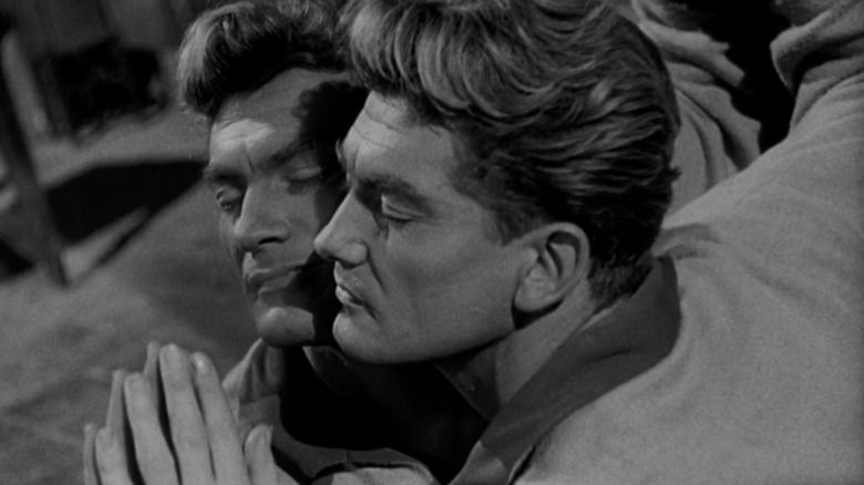 Orpheus presses his face against a mirror in "Orpheus" (1950)