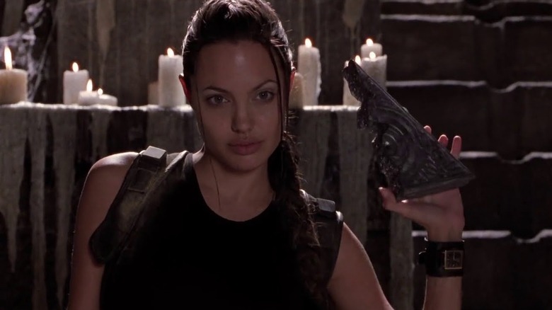Lara holding up an artifact in Lara Croft: Tomb Raider (2001)