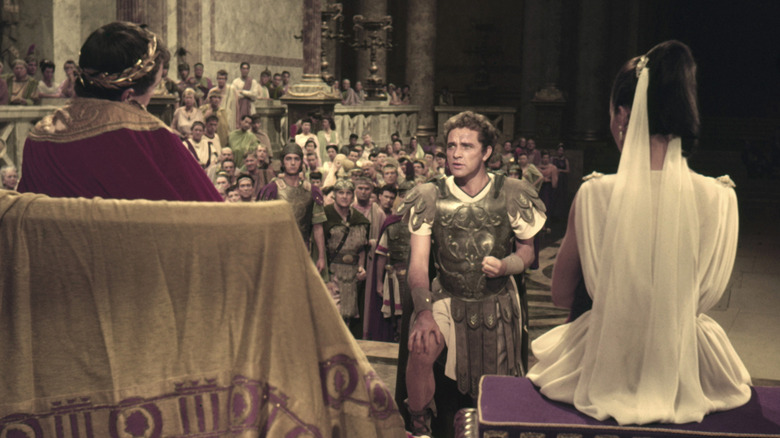 Marcellus kneels before Caligula