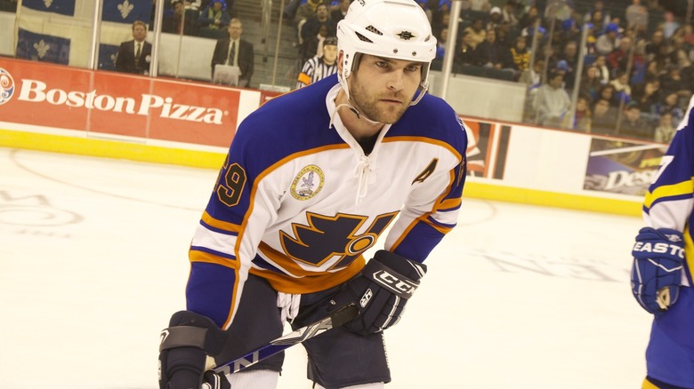 Doug on the ice holding a hockey stick in "Goon" (2011)