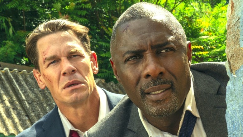 Derringer and Clarke peek out from behind a wall in 