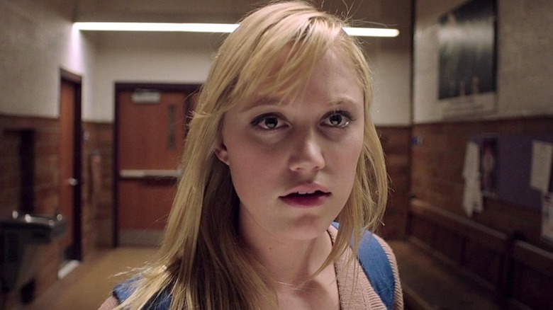 Jay Height is framed in a school hallway in It Follows