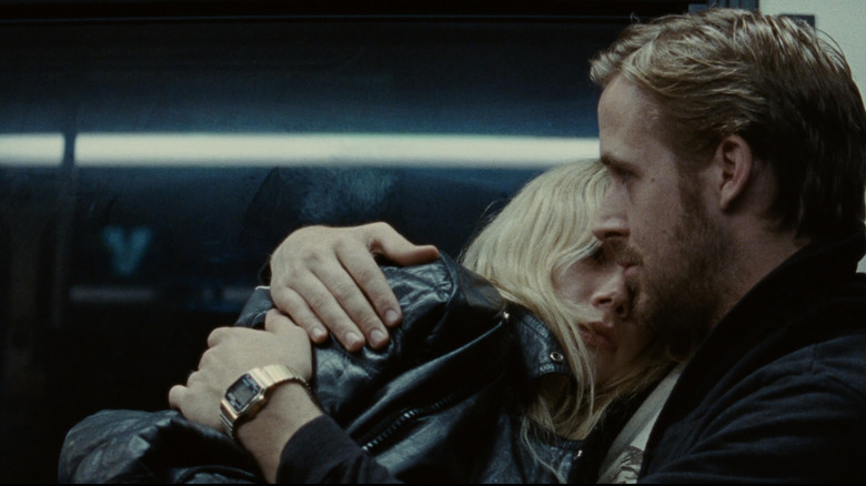 Dean holding Cindy, who is wearing a leather jacket