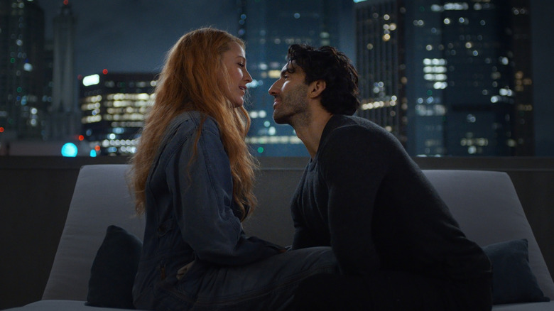 Ryle leaning in toward Lily on couch