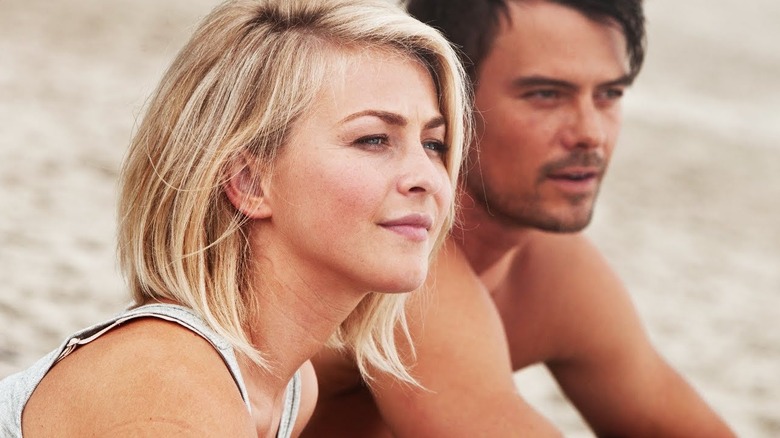 Erin sitting next to a shirtless Alex