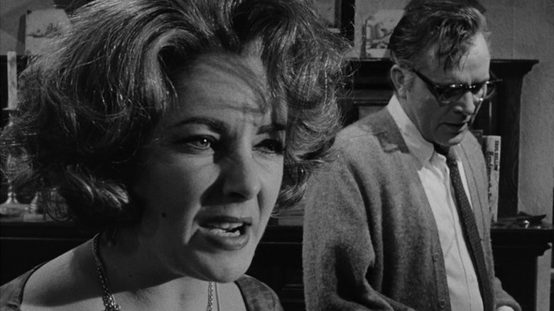 Martha scowling as George stands beside her