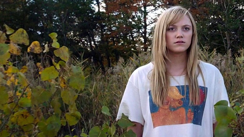 Jay standing nervously in the woods in "It Follows" (2014)