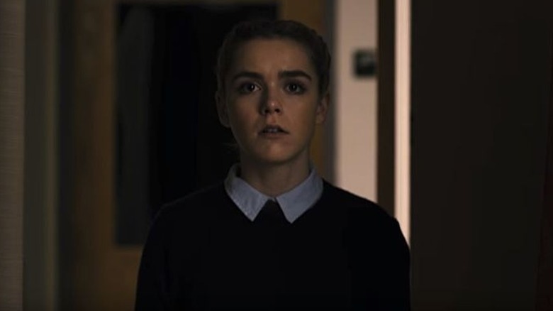 Katherine standing in a hallway in "The Blackcoat's Daughter" (2015)