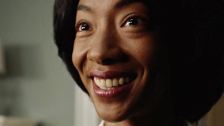 Georgina, smiling creepily and menacingly