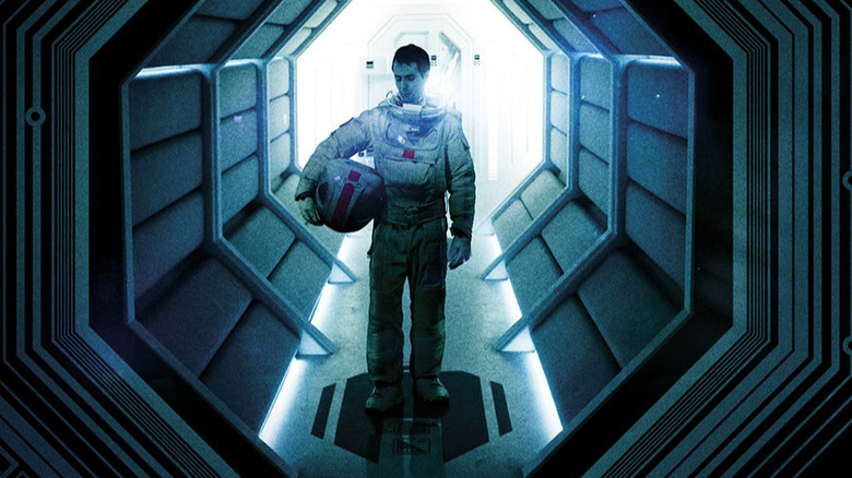 Sam in a space suit, standing in a hallway, in "Moon" (2009)