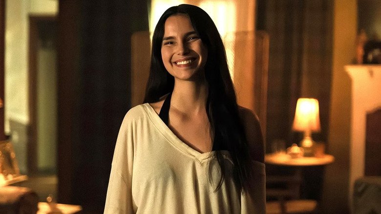 Nikki smiling widely in Obsession