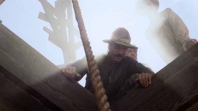 Plainview looks down a well in "There Will Be Blood" (2007)