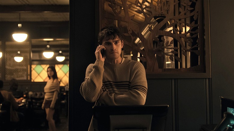Bear on the phone while Nikki spies on him in Obsession