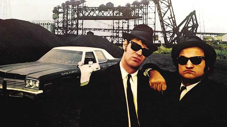 the blue brothers in front of a police car