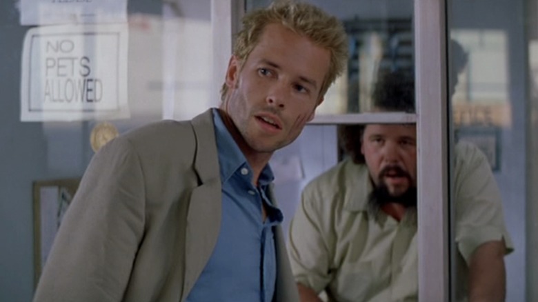 Leonard at the front desk of a hotel