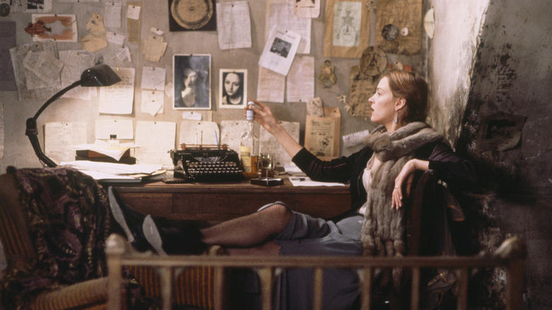 June sitting at desk holding bottle