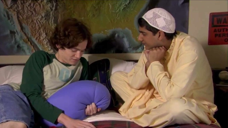 two boys sitting on bed