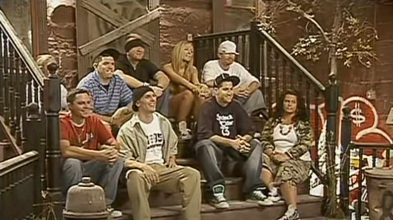 A group of rappers sit 
