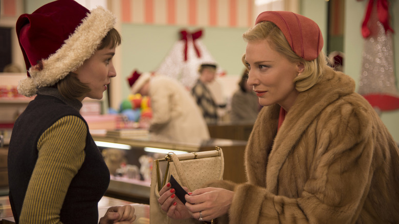 Rooney Mara as Therese in a Santa hat talking to Cate Blanchett as Carol in Carol (2015)