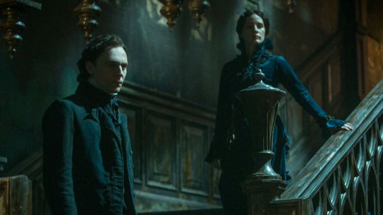 Tom Hiddleston and Jessica Chastain as Thomas and Lucille Sharpe on a staircase in Crimson Peak (2015)